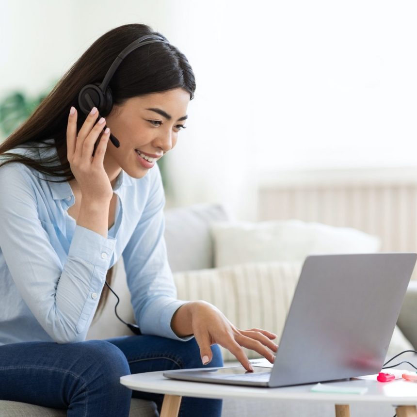 Asian Woman Studying Foreign Languages Online With Laptop And Headset At Home